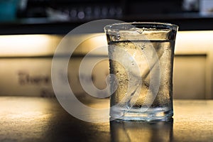 A glass of cold drinking water on table
