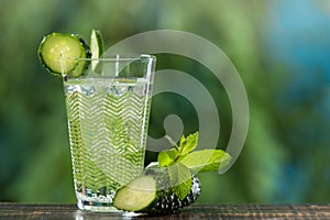 Glass with cold sparkling water, with cucumber and mint, a refreshing drink