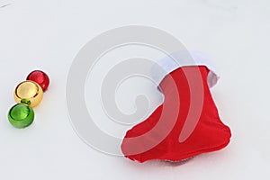 Glass color spheres and the red sock lying in snow