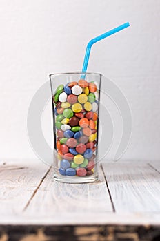 A glass with a colorful drink in the center of the frame. Vertical shot.