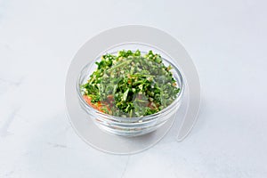 glass condiment cup of tabbouleh, tabouli