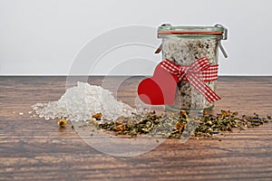 Glass container with bath salts and herbs