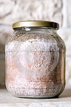 Glass container with inoculated fruiting fungal mycelium, home cultivation and fungiculture