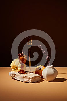 A golden fork, flower pot and pumpkins featured.