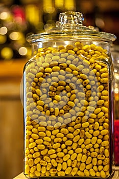 Glass cookie jar on shelf filled with yellow candy