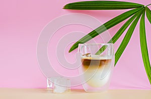 A glass that cover with some vapour of coffee mixing milk