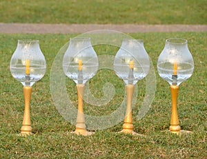 Glass-covered candle holders are used to light the night.