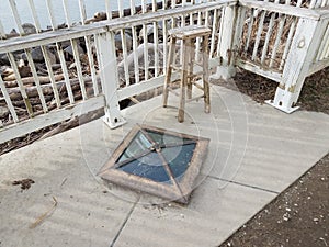 Glass covering over historical boundary marker with wood chair in Virginia