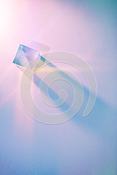 Glass cube with color spectrum rays. Abstract background with reflection and refraction of light. Shadow and rays of natural light photo