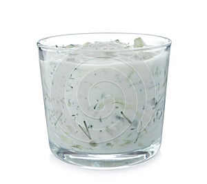 Glass with cucumber sauce on white