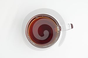 Glass cup of black tea isolated on white background. Top view.