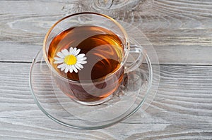 Glass cup with a camomile tea
