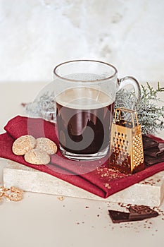 Glass cup of coffee cookies and cade branch in Christmas mood. Small gold grater