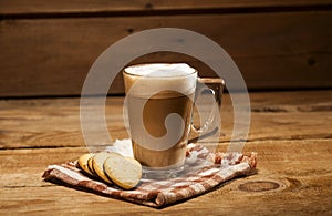 Glass cup with coffee and cookies in a heart shape