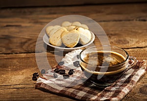 Glass cup with coffee and cookies in a heart shape