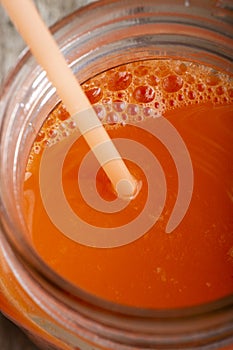 Glass cup of fresh carrot juice. macro shot