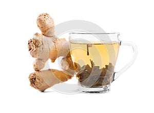A glass cup full of green organic tea. A tea cup and ginger on a white background. A beautiful cup with green