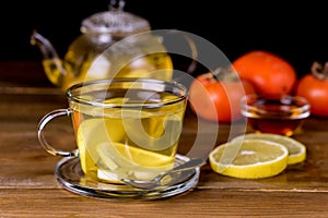 Glass Cup and Glass Teapot with Hot and Tasty Lemon and Ginger Tea Hot Autum Winter Drink Close Up