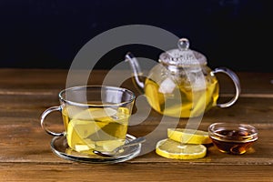 Glass Cup and Glass Teapot with Hot and Tasty Lemon and Ginger Tea Hot Autum Winter Drink Close Up