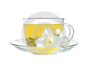 Glass cup of green tea with jasmine flowers isolated on white