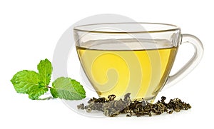 Glass cup of green tea and mint on white background