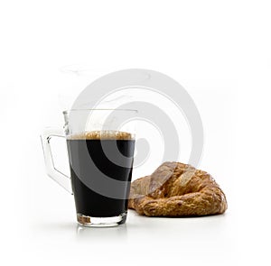 Glass cup with handle and coffee only inside with a croisant photo