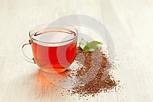 Glass cup of healthy natural herbal rooibos tea on