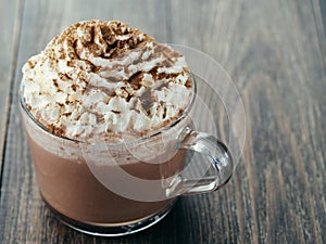 Glass cup with hot chocolate and whipped cream