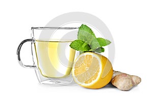 Glass cup with hot ginger tea, mint and lemon