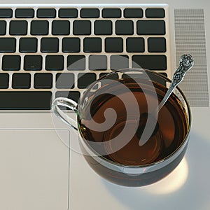 Glass cup of hot tea on laptop on white hardwood table. Top view