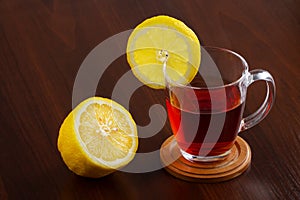 Glass cup of hot tea and a lemon