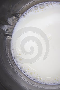 Glass cup with milk on wooden background