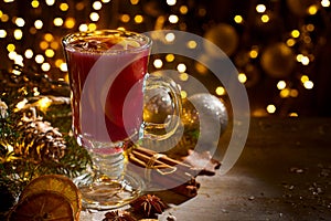 Glass cup of mulled wine on christmas decorations