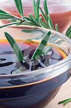 Glass cup with soy sauce and rosemary