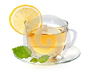 Glass cup of tea with lemon and leaf mint