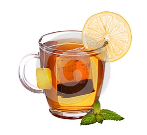 Glass cup of tea with lemon and mint on white