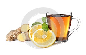 Glass cup of tea, lemon slices and ginger