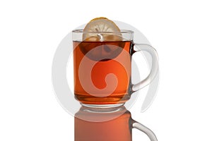 Glass Cup of tea with lemon on a white isolated background with a shadow on the table