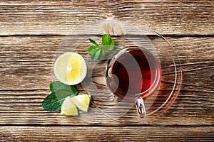 Glass cup with tea, mint and lemon