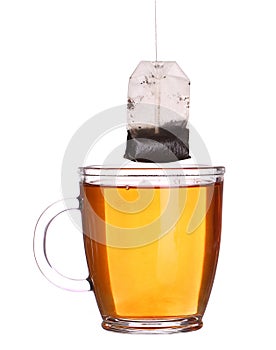 Glass cup of tea with tea bag isolated on white