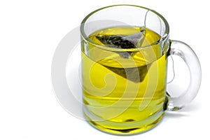 Glass cup with teabag, green tea. Isolated on a white