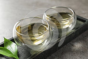 Glass cups of freshly brewed oolong tea on table