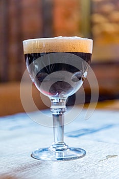 A glass of dark Belgian beer