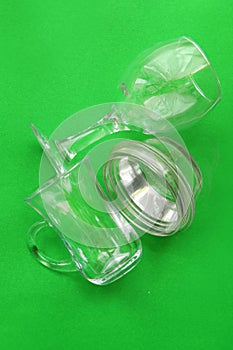 Glass debris on a green monochrome background. Concept of waste recycling