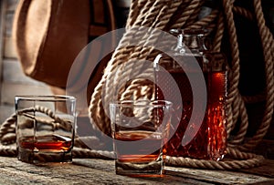 Glass and decanter of whiskey on a old wooden table