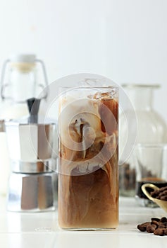 Glass of Delicious Ice Cold Brew with Milk and Coffee Beans