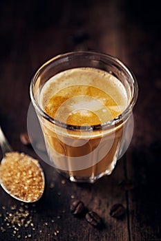 Glass of delicious Latte Coffee on rustic wooden background