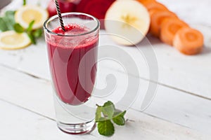 Glass of detoxifying beet, apple, lemon and mint juice