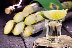 Glass of distilled beverage made from sugar cane, called the year Brazil de pinga or cachaÃÂ§a, concept of the national day of