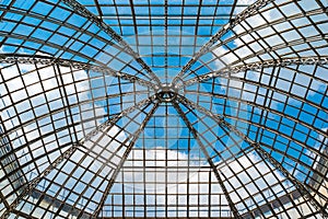 Glass dome roof is against the blue sky